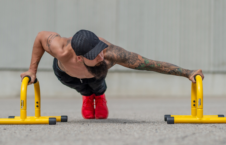 Man working out with parallette bars